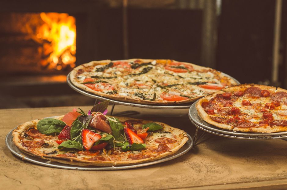 Compact pizza oven on a small patio table in a garden