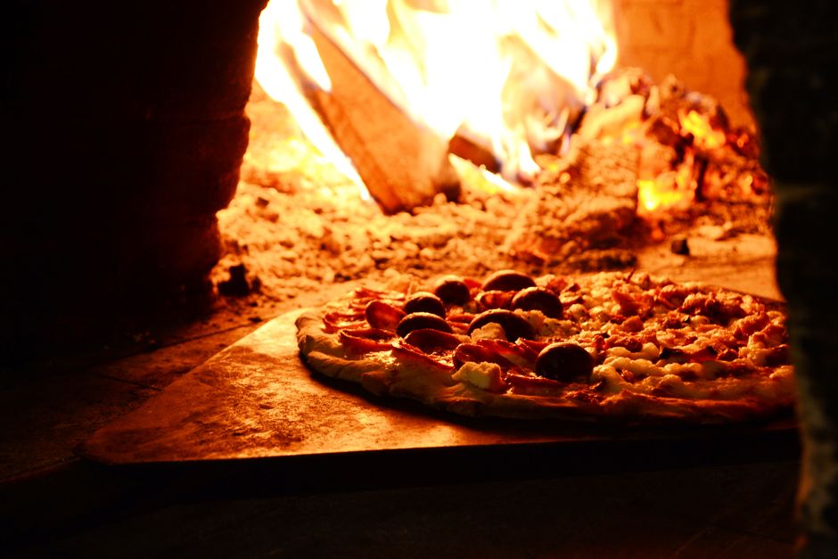 Modern compact gas pizza oven on a patio in the evening